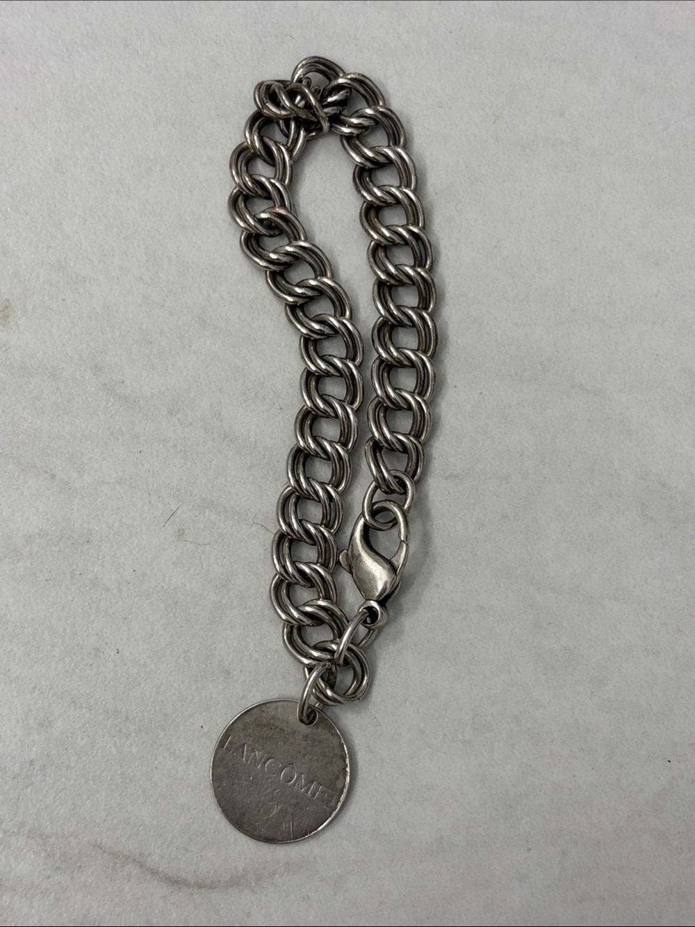 Lancome Silver Chain Bracelet with Round Logo Disc